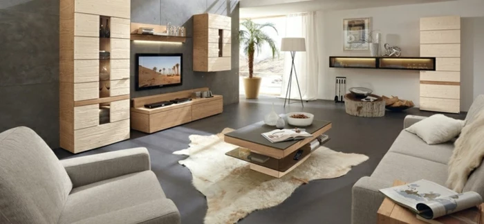 grey floor with white rug, small wooden coffee table, luxury living room furniture, grey sofa and armchair