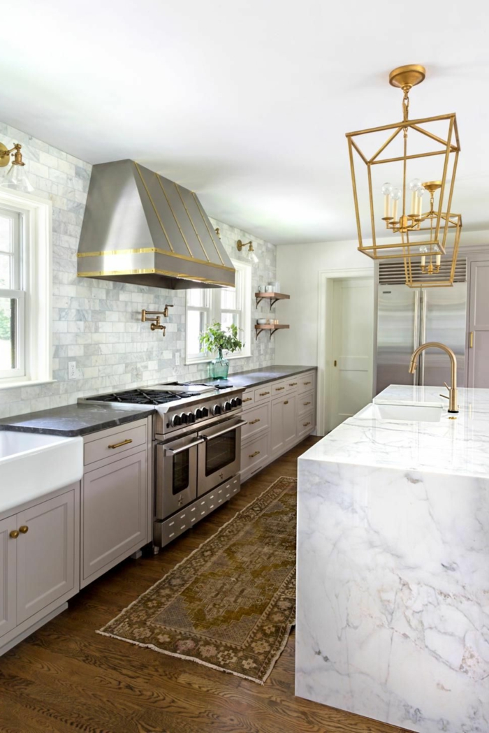 grey and white subway tiles backsplash, mid century modern tile, marble kitchen island, laminated wooden flooring