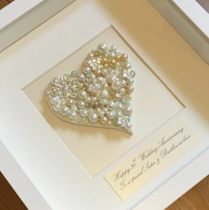 heart made out of pearls, congratulatory message underneath, inside a white wooden frame, 10th anniversary gift