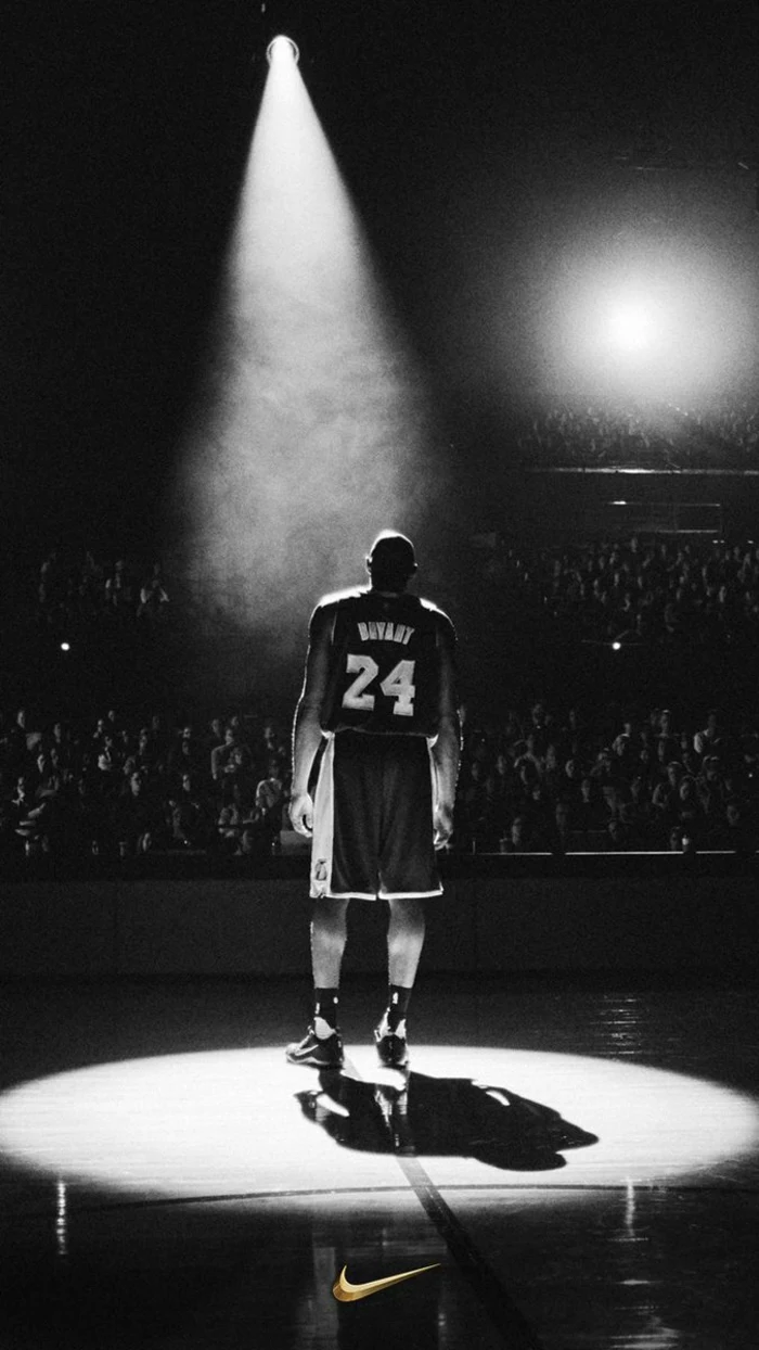 kobe bryant, standing on the court, under a spotlight, nike basketball wallpaper, black and white photo