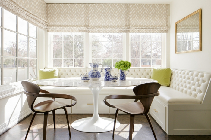 breakfast nook, bench with white cushions, wooden chairs and white table, mid century modern backsplash