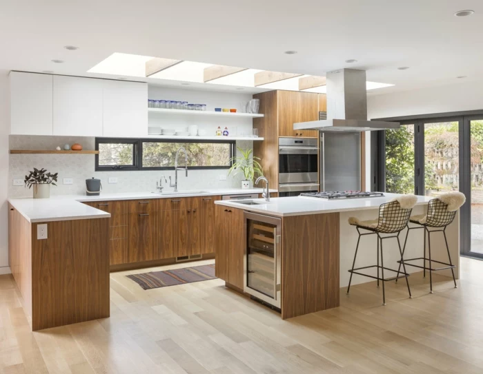wooden cabinets with white countertops, mid century modern backsplash, laminated wooden flooring