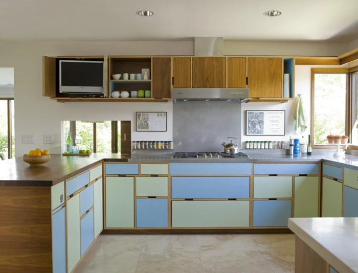 pastel blue and green cabinets, mid century modern kitchen island, grey countertops, tiled floor