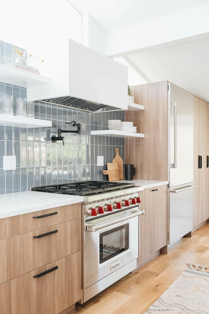 wooden cabinets with white countertops, mid century modern kitchen island, grey subway tiles backsplash