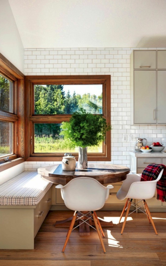 white subway tiles backsplash, mid century modern kitchen island, breakfast nook, round wooden table