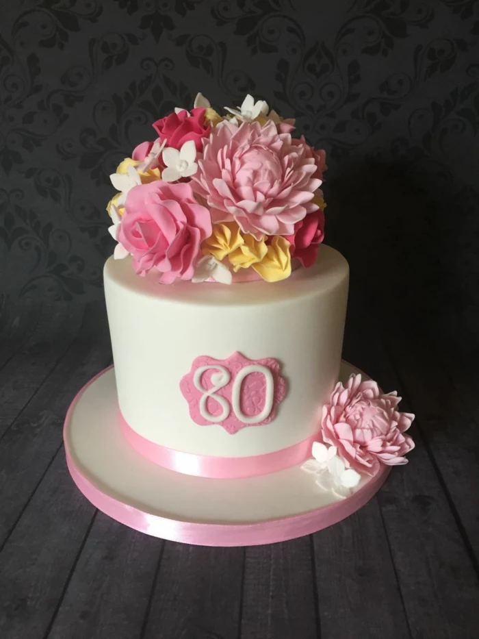 one tier cake, covered with white fondant, 80th birthday party decorations, decorated with flowers on top