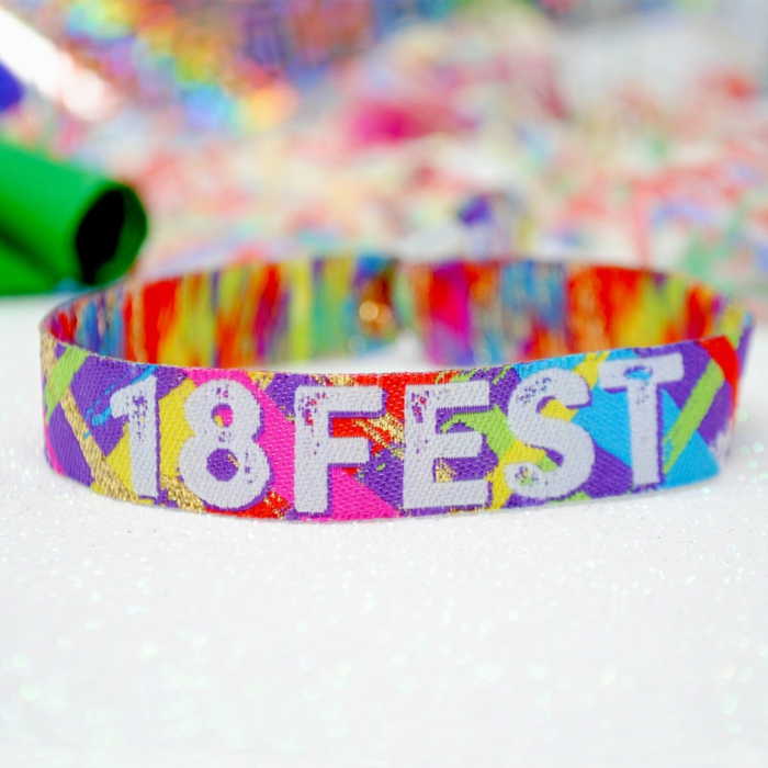 colorful party wristbend, 18 fest written on it with white letters, things to do for 18th birthday, purple pink and green and yellow