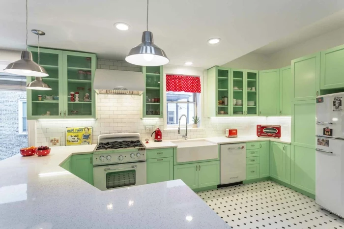 pastel green cabinets, white countertops, mid century kitchen island, tiled floor