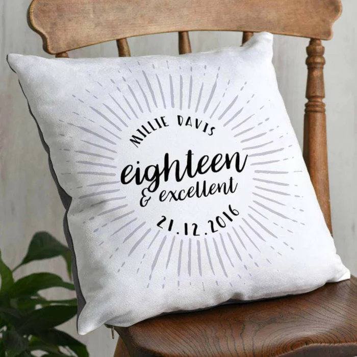 personalised throw pillow, eighteen and excellent written on it, things to do for 18th birthday, placed on wooden chair