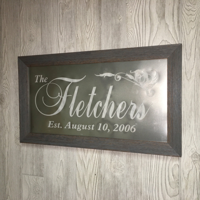 the fletchers iron poster, inside a black wooden grame, 40th anniversary gifts, placed on wooden surface