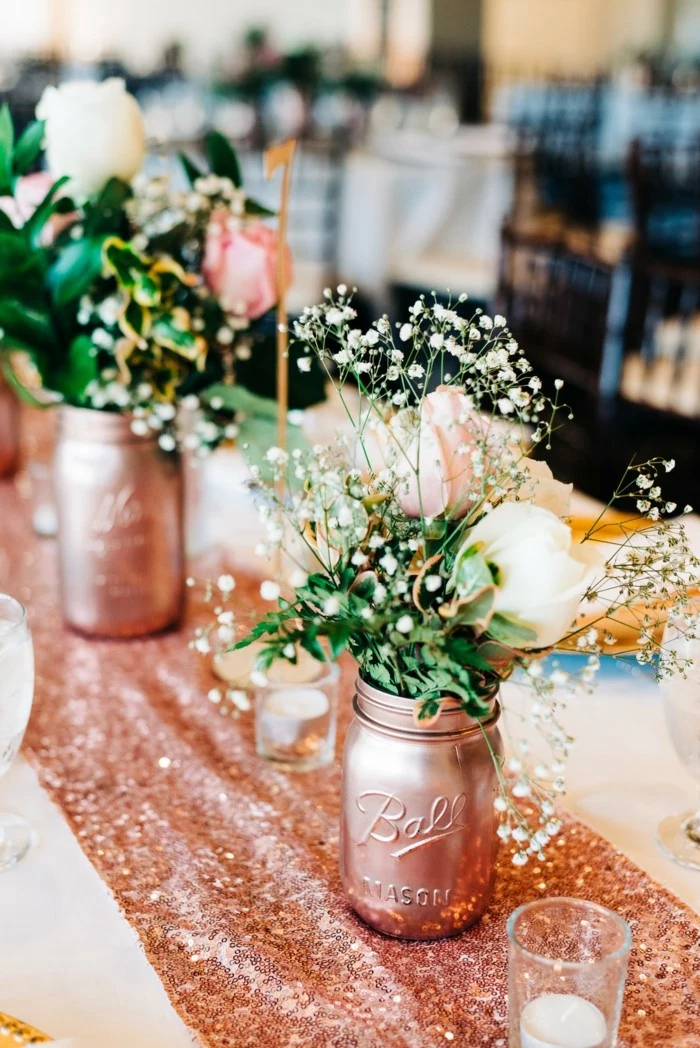 pink and white roses bouquets, placed inside mason jars, painted in rose gold, 18th birthday party ideas, rose gold table runner