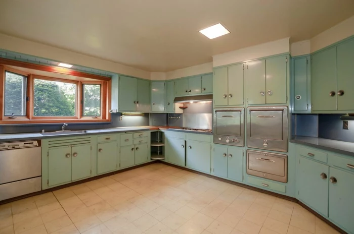 light green pastel cabinets, light grey countertops, mid century modern floor tile, white tiles on the floor