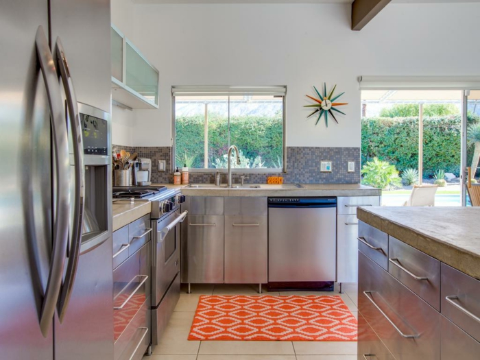 white tiles on the floor, mid century modern floor tile, granite countertops, orange carpet, mosaic backsplash