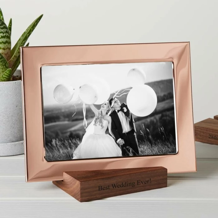 copper photo frame, black and white photo of the bride and groom, 25th anniversary gifts, wooden stand with best wedding ever written on it