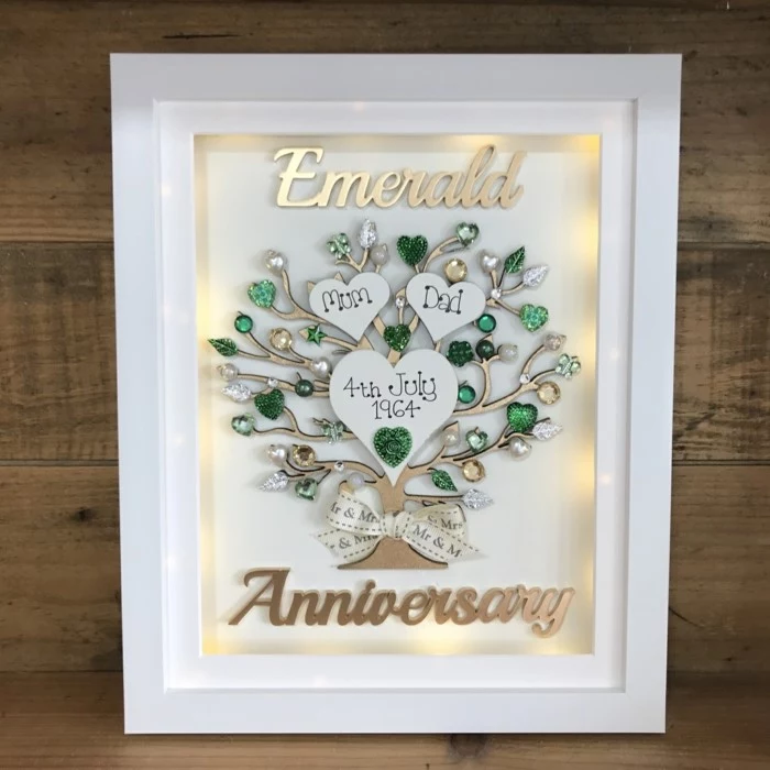 tree made of emerald crystals, inside white wooden frame, anniversary gifts for couples, placed on wooden surface