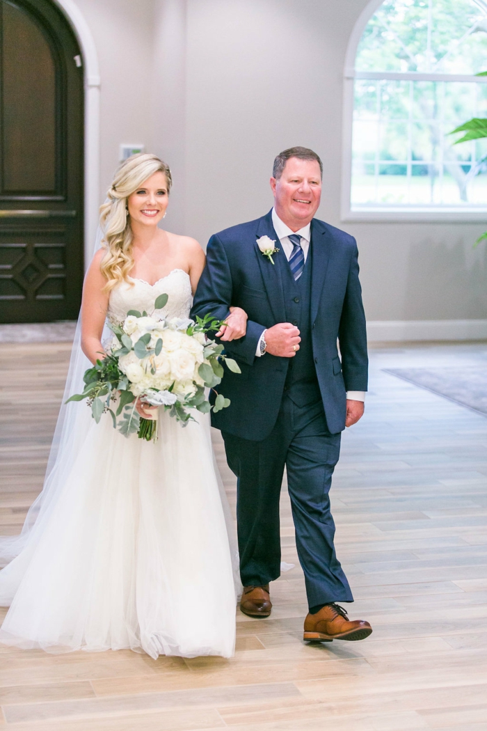 bride being walked down the aisle by her father, bride walking down the aisle songs, holding a large bouquet