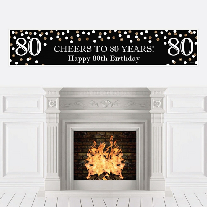 cheers to 80 years banner in black and gold, happy 80th birthday, hanging over a fireplace