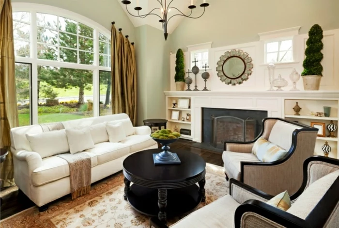 white sofa and armchairs, luxury living room furniture, black wooden round coffee table, coloful carpet