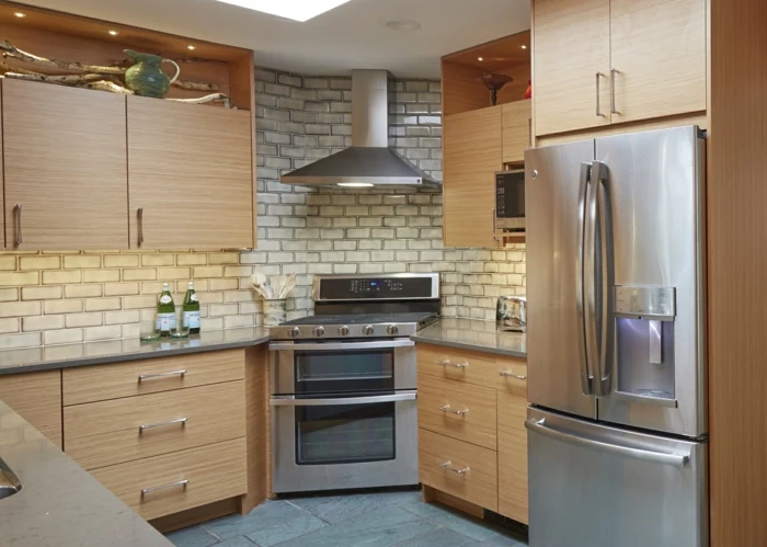 white subway tiles, mid century modern kitchen appliances, wooden cabinets with light grey countertops