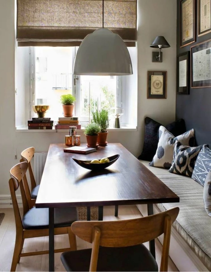 breakfast nook, wooden table and chairs, mid century modern kitchen appliances, black and white throw pillows