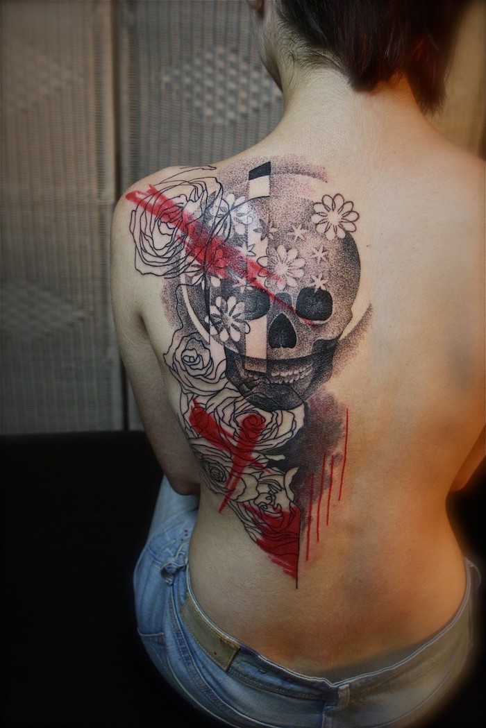 back tattoo of large skull surrounded by flowers roses trash polka tattoo ideas red lines around it