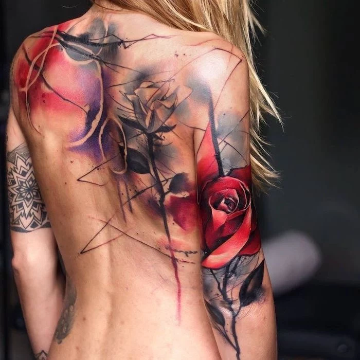 back tattoo on blonde woman trash polka eagle tattoo two roses circles tattoo going across back and back of arm