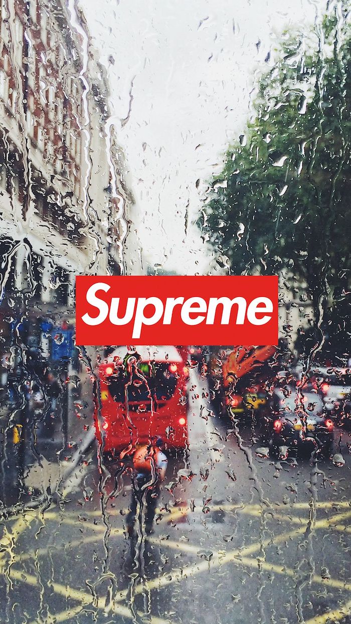 background photo of london street with red bus taken from behind a glass with rain drops cool hypebeast wallpapers red and white supreme logo at the center