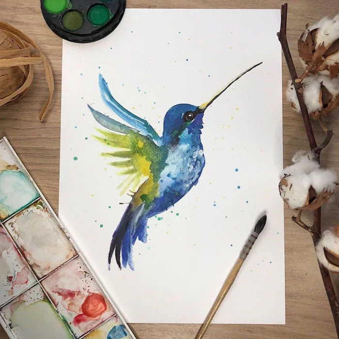 blue hummingbird with green wings, easy watercolor paintings, painted on white background, placed on wooden surface
