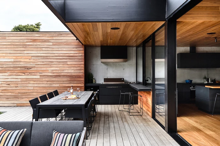 black cabinets and chairs how to build an outdoor kitchen wooden table ceiling and floor black countertops