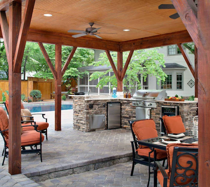 black metal chairs with orange cushions outdoor bbq ideas kitchen island made of stones with metal fridge and grill outdoor bbq ideas next to the pool