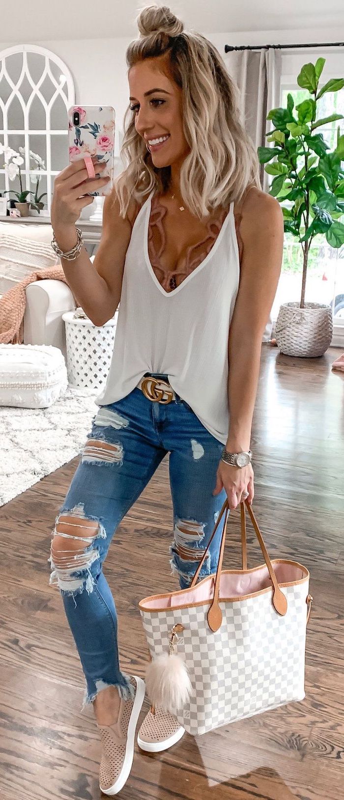 blonde woman wearing ripped jeans white top brown lace bralette cute summer clothes louis vuitton bag