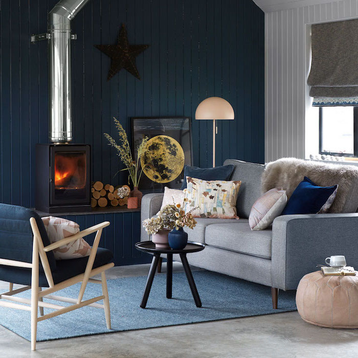 farmhouse decor, blue wooden accent wall, blue armchair and grey sofa, blue carpet on granite floor