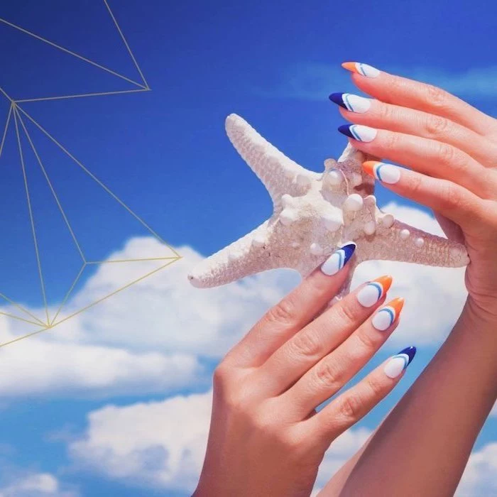 long almond nails, white nail polish, orange and blue french tips, summer acrylic nails, sky in the background