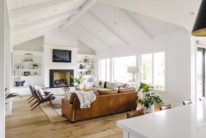 brown leather sofa, black armchairs, white sofa placed in front of a fireplace, farmhouse decor ideas, wooden floor