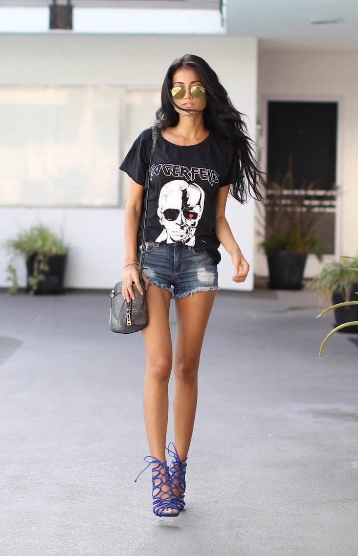 brunette woman with long wavy hair pinterest cute outfits wearing denim shorts black t shirt blue heeled sandals