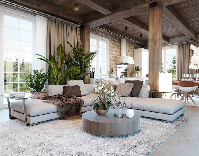 white corner sofa, wooden ceiling, brick accent wall, round wooden coffee table, rustic home decor, white carpet on granite floor