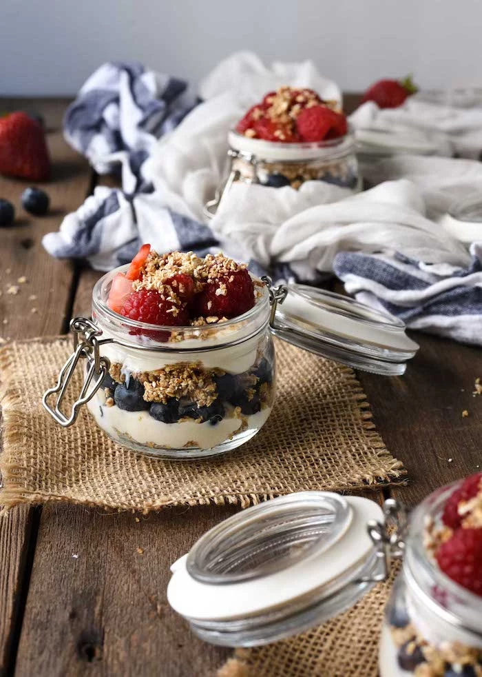 cheesecake parfaits made with oatmeal blueberries and strawberries no bake dessert recipes layered in glass jars