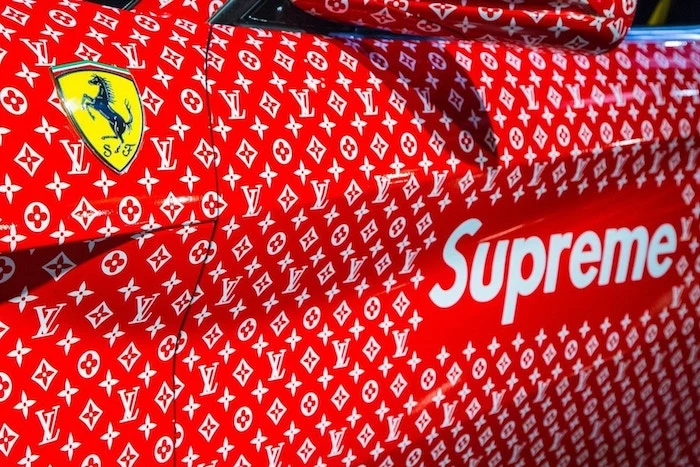 close up photo of ferrari covered in louis vuitton supreme logos cool wallpapers supreme ferrari emblem