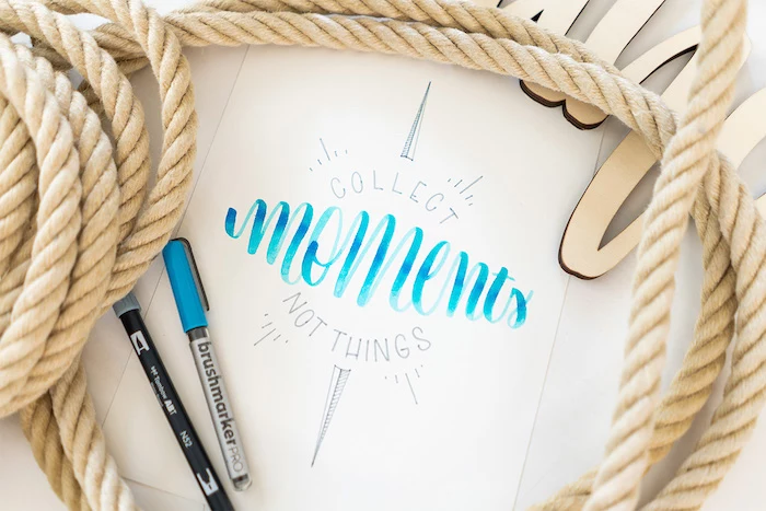 collect moments not things written with blue and black letters on white background hand lettering different fonts