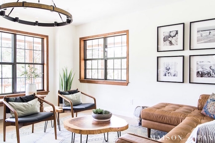 brown corner sofa, black armchairs, rustic home decor, small wooden coffee table, white walls