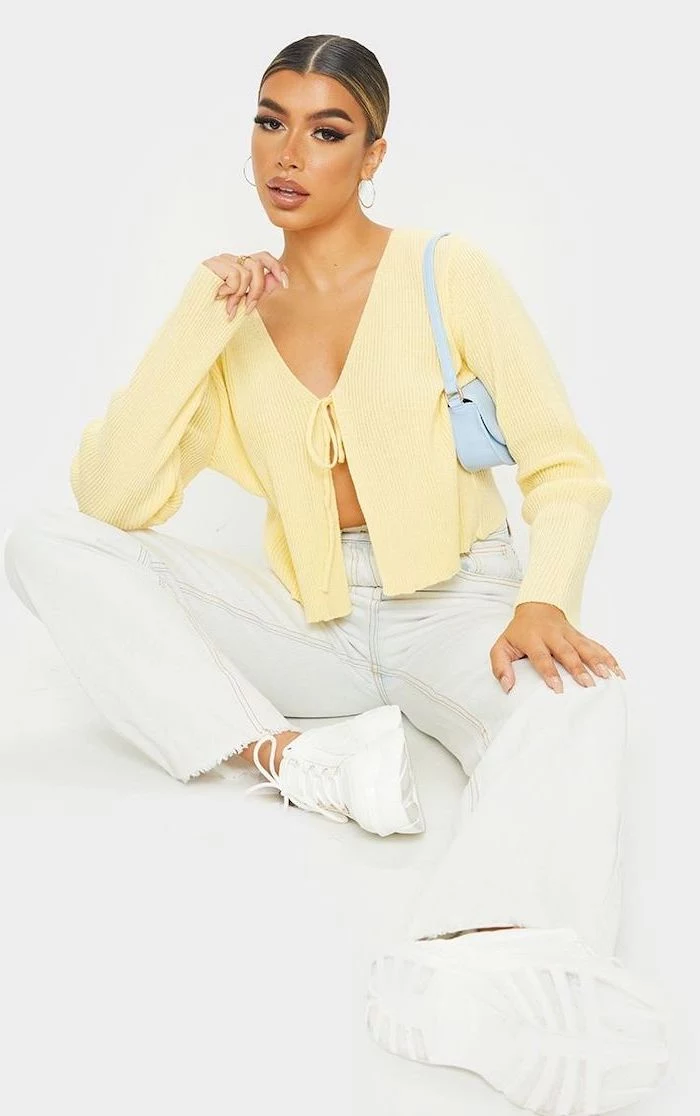 cute outfits for women woman wearing white jeans and sneakers yellow cardigan loosely tied at the front
