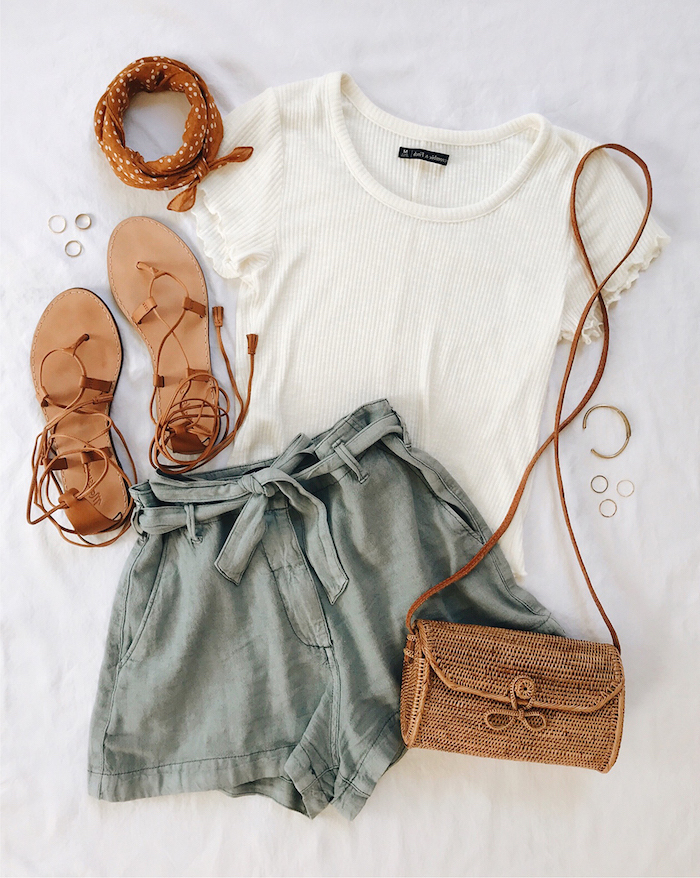 dark grey shorts white t shirt brown leather sandals bag laid out on white surface cute outfit ideas for summer