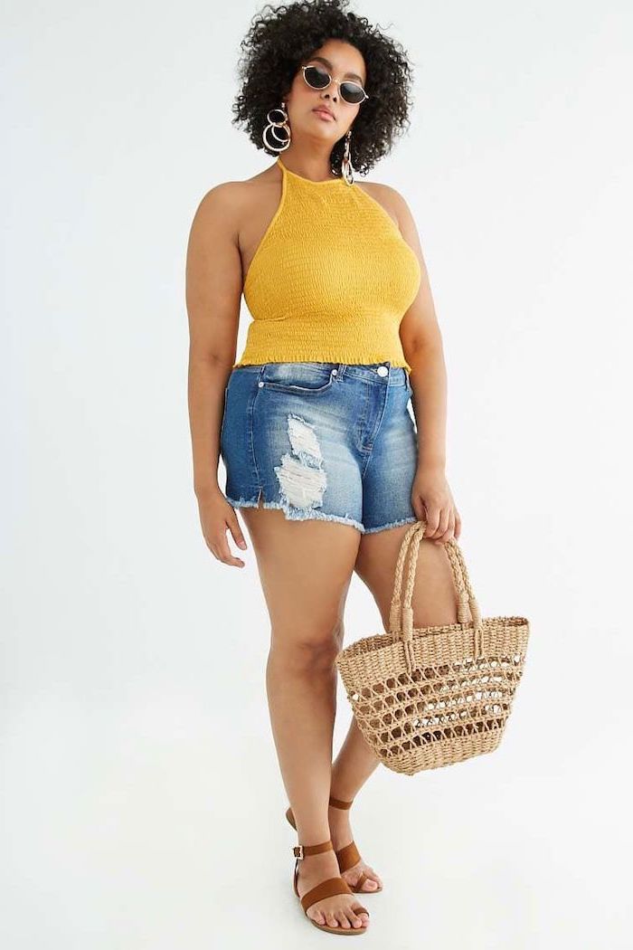 denim shorts yellow top summer outfits for women worn by woman with black curly hair along with brown leather sandals