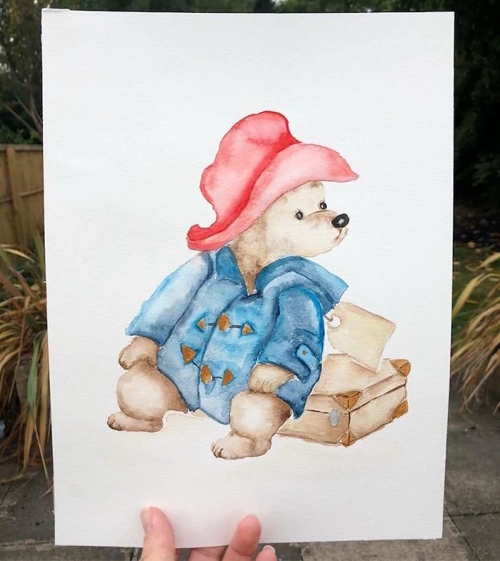 painting of paddington, sitting on his suitcase, beginner easy painting ideas, wearing blue coat and red hat