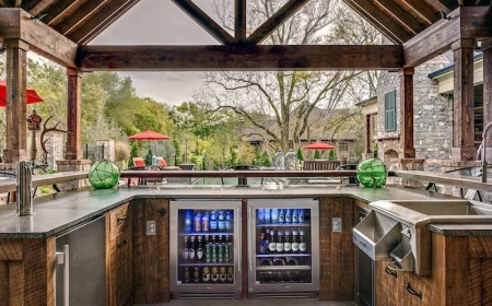 drinks fridge and wooden cabinets with marble countertop backyard kitchen ideas wooden caulted ceiling kitchen next to the pool
