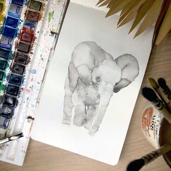 painting of an elephant, easy watercolor flowers, painted on white background, placed on wooden surface