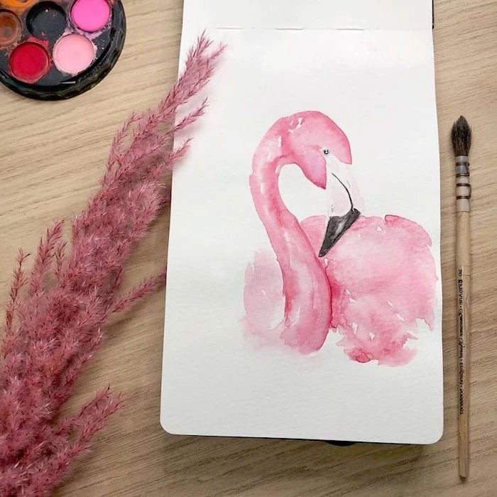 painting of a flamingo, painted in pink, easy watercolor flowers, painted on white background, placed on wooden surface