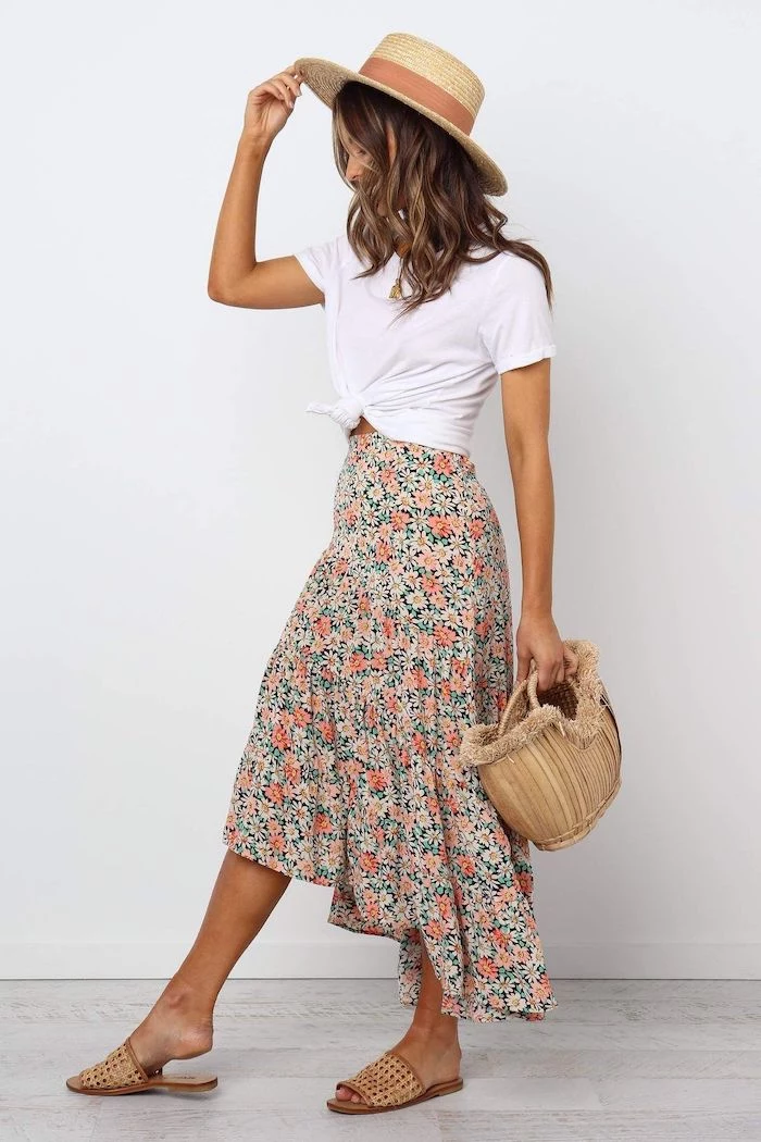 floral skirt white t shirt worn by brunette woman summer outfits brown hat and sandals bamboo bag
