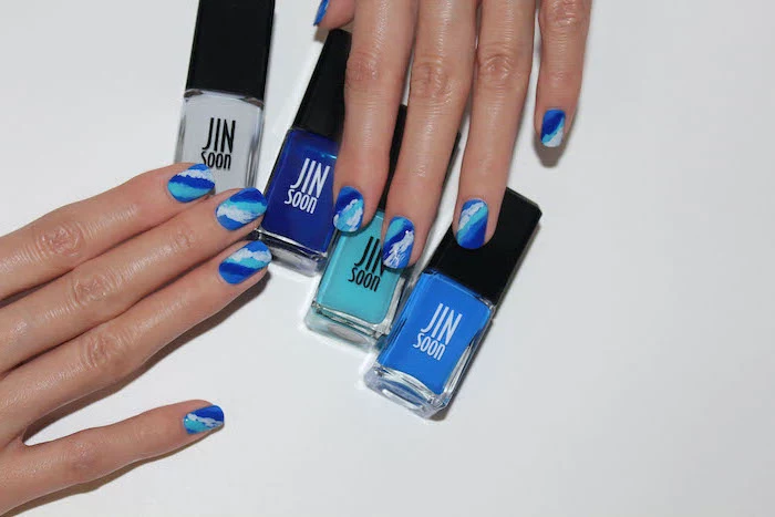 ocean waves decorations, shades of blue and white nail polish, gradually mixed together, cute nail designs