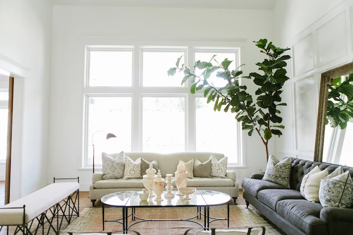 grey and white sofas, white ottoman, farmhouse style homes, glass coffee table, white walls